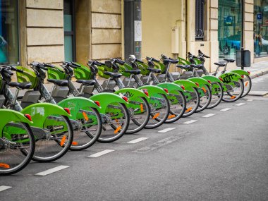 08 21 2024 - Paris, France. Cycling tourism in Paris. Row of rental Velib bikes parked in a street clipart