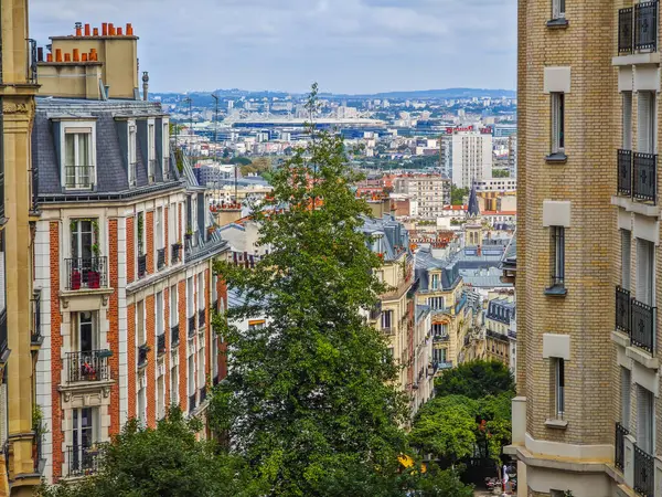 stock image 09 15 2024 - Paris, France. Paris street photography. Cozy street in Montmartre Paris with city panoramic view