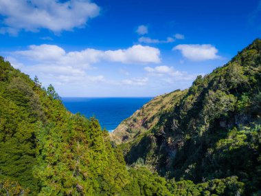 Canyon view from Poco Azul the blue lagoon of the Azores, Sao Miguel, Portugal. Aerial drone view of Poco Azul waterfall clipart