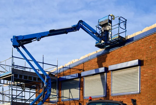 Access platform equipment powered high in sky at construction building site UK