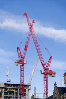 Tall cranes at new office construction in Glasgow city centre UK