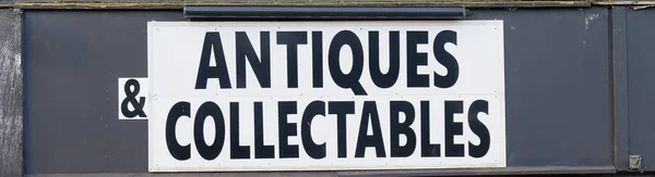Antiques and collectables sign above shop entrance UK