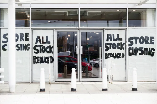 stock image Store closing clearance sale now on sign in shop window UK