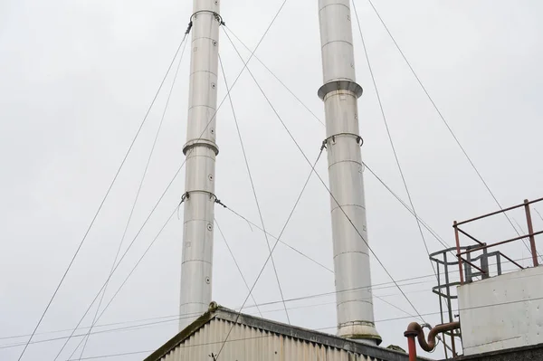 stock image Flue chimney fixed to building exterior wall stainless steel from exhaust boiler plant room UK