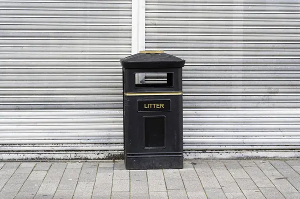 Black litter bin for rubbish in public area UK