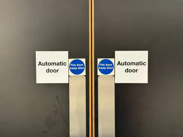Automatic door keep shut sign on fire door UK