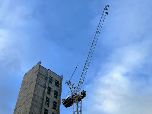 Tower cranes at new high rise apartment development during construction UK