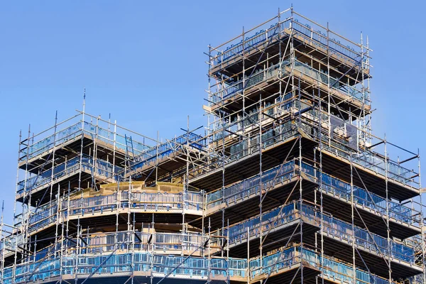 Scaffolding surrounding residential development for safe access to construction work UK