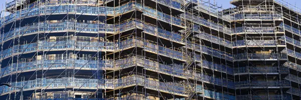Scaffolding surrounding residential development for safe access to construction work UK