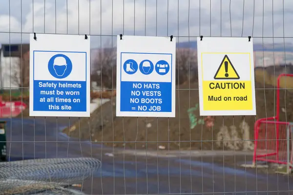 Construction site health and safety message rules sign board signage on fence UK