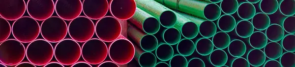 Plastic ducts stacked for underground cables at construction site UK