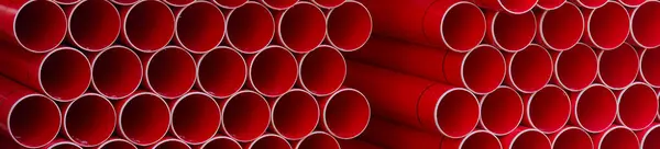 Plastic ducts stacked for underground cables at construction site UK