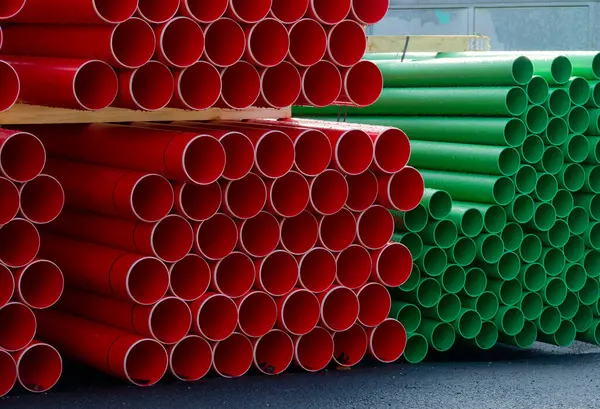 Plastic ducts stacked for underground cables at construction site UK