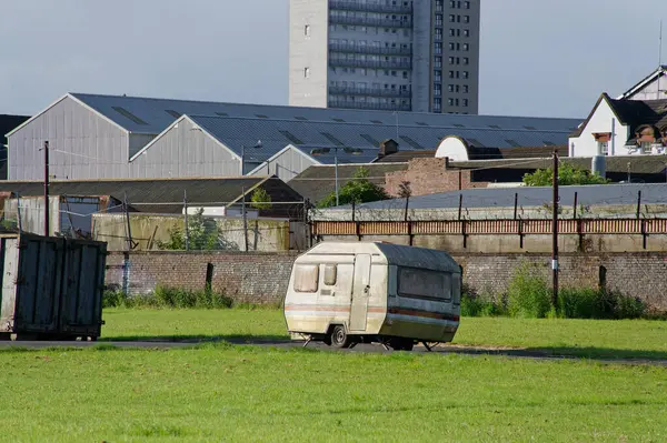 stock image Caravan abandoned and dumped in street waiting to be removed UK