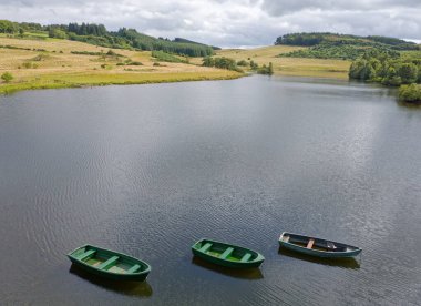 Fishing boats on Knapps Loch in Kilmacolm UK clipart