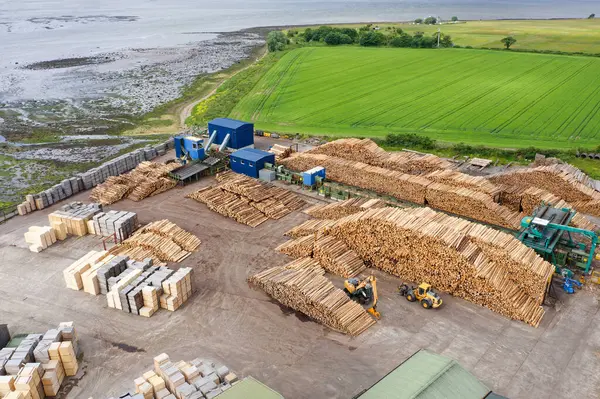 stock image Sawmill with chopped wood logs stacked and machinery UK