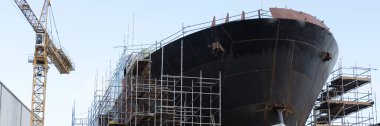 Shipbuilding and crane during ferry construction surrounded by scaffold UK