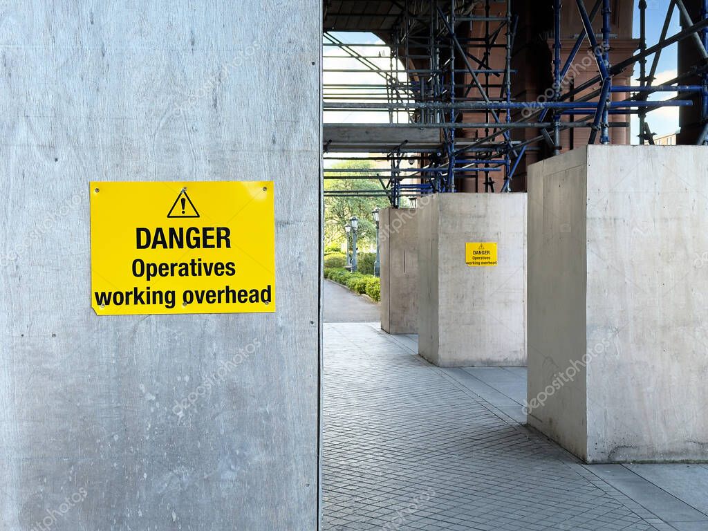 Construction site health and safety sign on fence UK