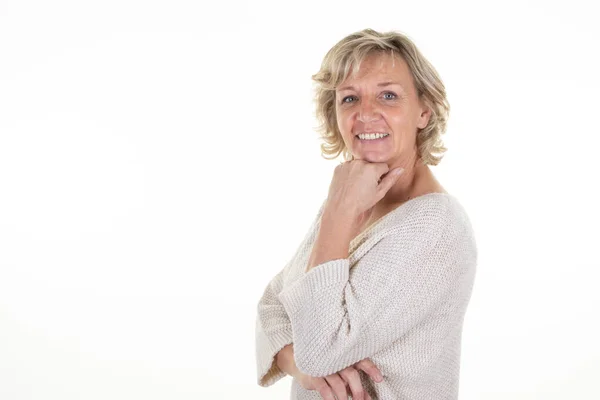 stock image portrait of 60 senior blond woman with blonde hair with blue eyes on white background and beautiful smile