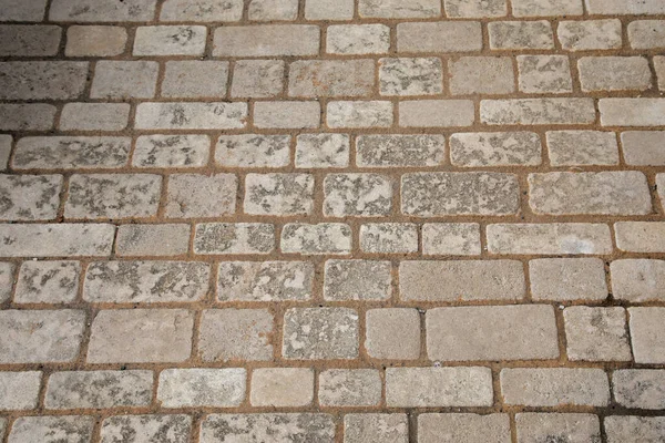 石の古い床の壁のヴィンテージテクスチャベージュの背景サイド異なるサイズの砂の石 — ストック写真