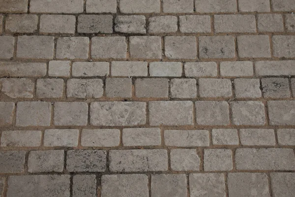 石ベージュの床古い壁のヴィンテージテクスチャ背景サイド異なるサイズの石 — ストック写真