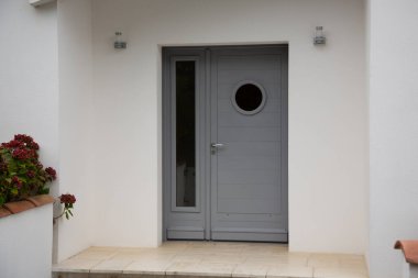 Çağdaş gri giriş kapısı olan modern ev cephesi