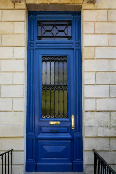 blue classic wooden Door on french wall entrance windows gate street facade