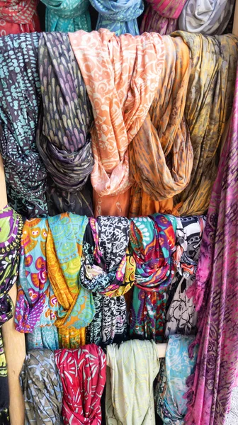 scarf display store with colorful scarfs on a market stall Colored scarves background shop