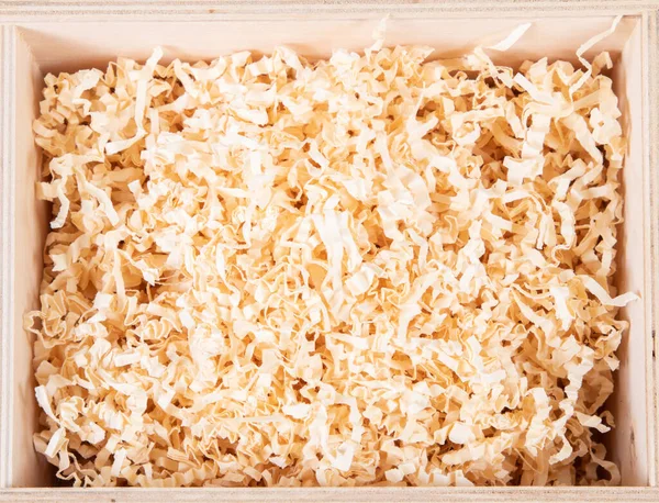 packing wood shavings chips on white background on fiber carton recycled