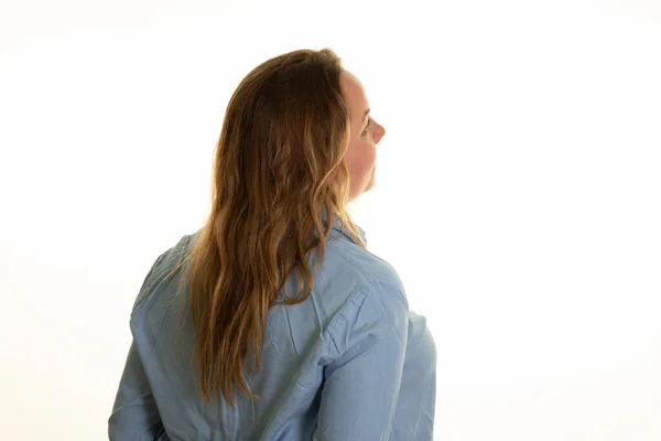 overweight rear view woman from behind in blue shirt arms along the body on white background