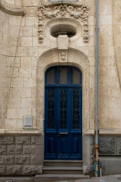 blue wooden front door of new restored house entrance dark classic gate in europe france