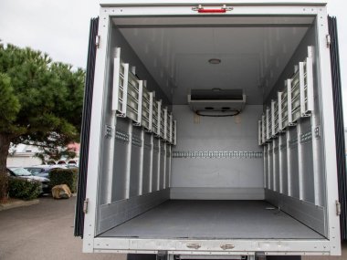 interior van of an empty panel truck with large doors open on empty place small vehicle clipart