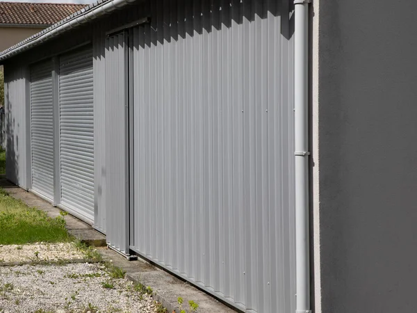 metallic gray curtain door of facade store closed roller grey modern home garage gate access house