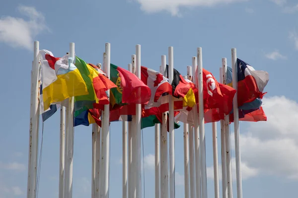 stock image full of flags of different international countries on top of masts