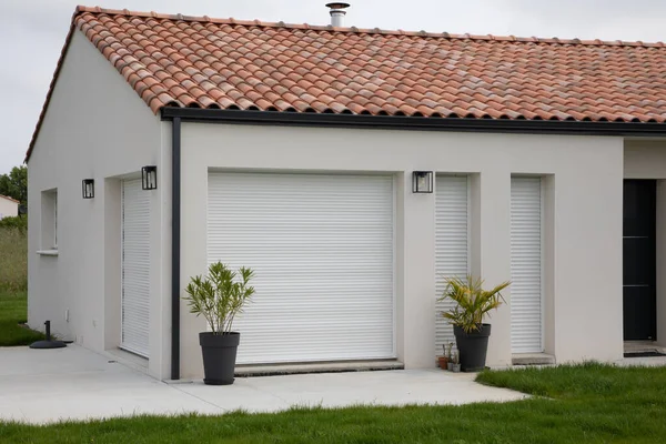 stock image facade of modern house with terrace and closed pvc rolling shutters of new suburban home