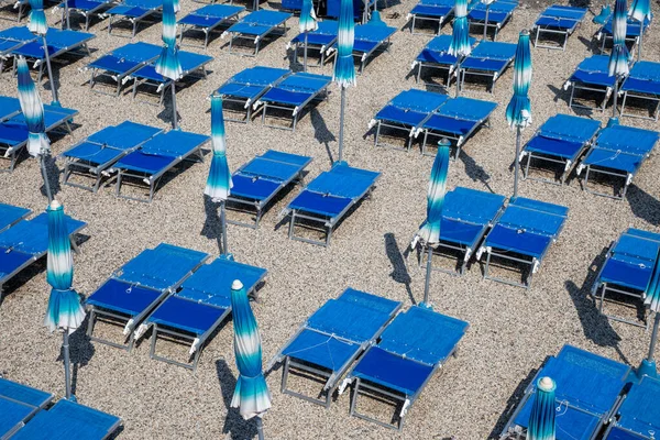 stock image beach umbrellas and recliner chairs  in a private sand beach in italiy coast