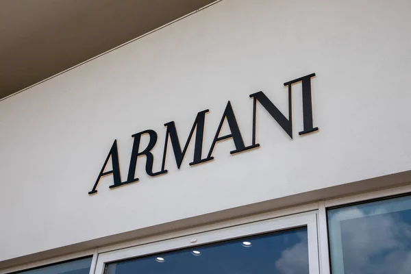 stock image Milan , Italy  - 07 15 2023 : Armani facade shop wall facade sign brand and text logo of store clothing company italian