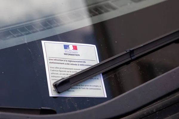 information parking ticket traffic text sign paper by policeman French police for car violation of parking regulations by police france patrol in town street