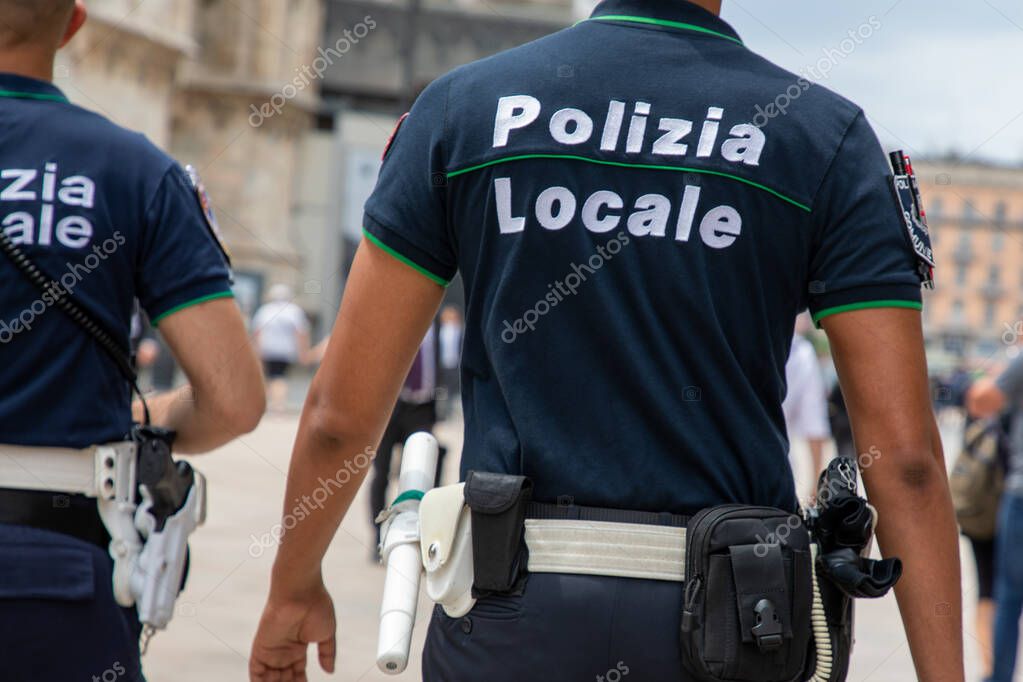 Milan , Italy  - 08 17 2023 : polizia locale policeman shirt with text sign police italian local police patrol in city street
