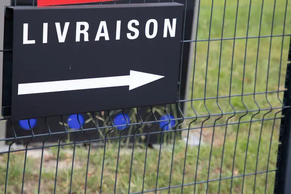 French sign livraison means delivery on fence wall reception trucks