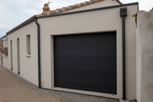 facade of modern house with grey dark closed rolling shutters of new restoration home