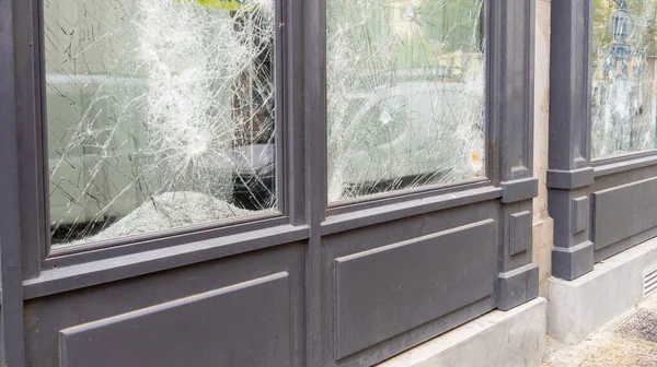 broken shop windows facade in town center smashed during protesters symbolizing the latest riots in city