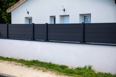 Gri duvarlı modern bariyer, banliyö tasarım koruma bahçesinin özel evinin çitleri.