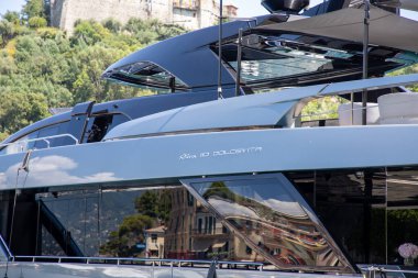 como , italy - 11 16 2023 : riva 110 dolcevita boat sign text and brand logo on flybridge yacht launched in La Spezia in the shipyard that builds composite boats clipart