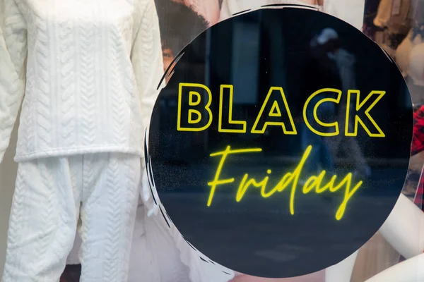 Black friday text sign stickers on facade store windows entrance shop for discount price