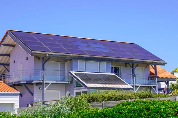 Solar system covers roof panel on a residential house building