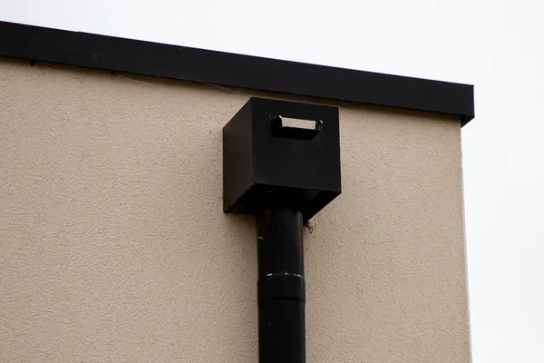 Box Rain Gutters corner of the house with flat roof with modern gutter pipe rectangular shape