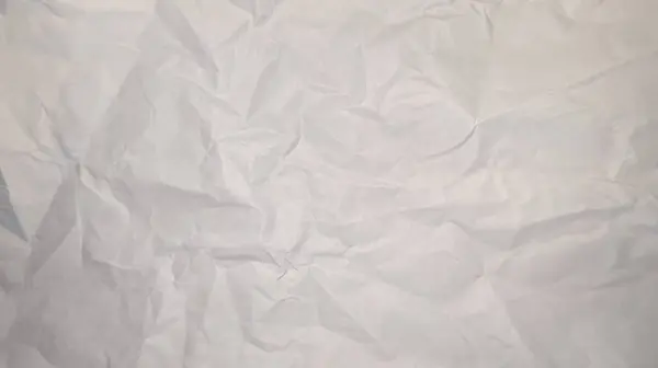 White crumpled crumpled sheet of paper with random creases texture background