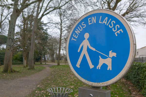 Please keep your dog on a lead information french text sign means  france chien tenus en laisse to protect wildlife and other people walking in the area from a dog attack