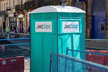 Bordeaux , France -  03 17 2024 : wc loc wcloc rental sign brand and text logo on green and grey porta potties rent for construction site clipart